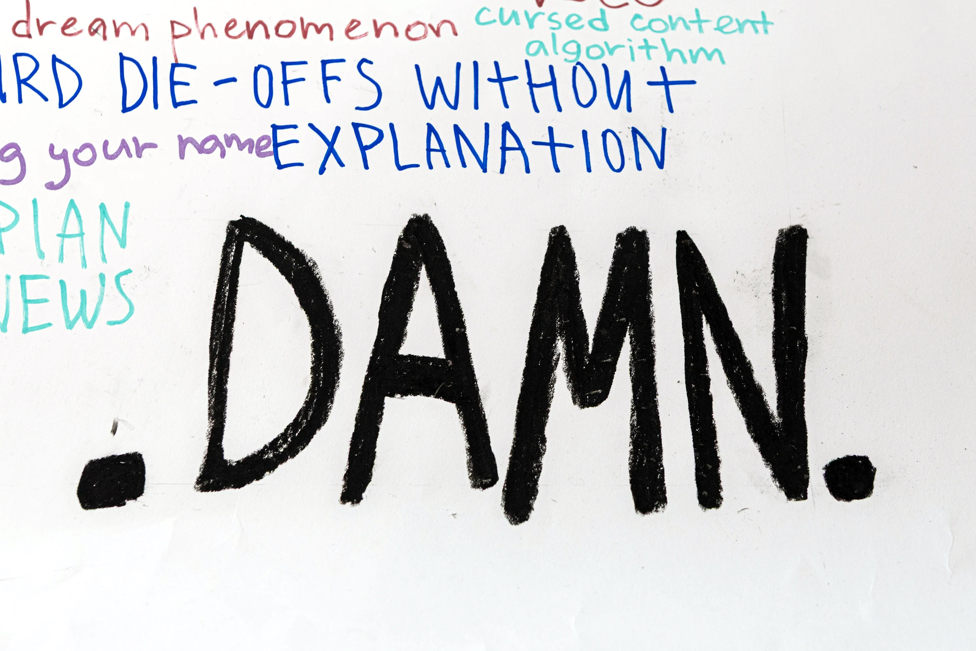 Detail: the word DAMN. in heavy black capitals, closing the banner, with a list of internet subjects above it.